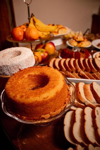 a table with pies and other desserts on display at Pousada Charm Canela in Canela