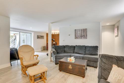 a living room with a gray couch and a table at Walk to Mohican Lake Catskills Getaway with Dock! in Glen Spey