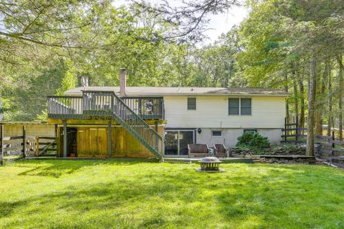 a house with a large yard with a deck at Walk to Mohican Lake Catskills Getaway with Dock! in Glen Spey