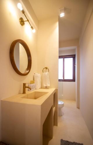 a bathroom with a sink and a mirror and a toilet at Ocean Views Amazing Rooftop in Mazunte