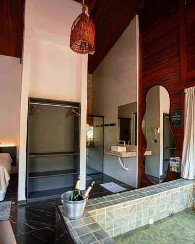 a bathroom with a sink and a mirror at Azzuro Hotel in Guaramiranga