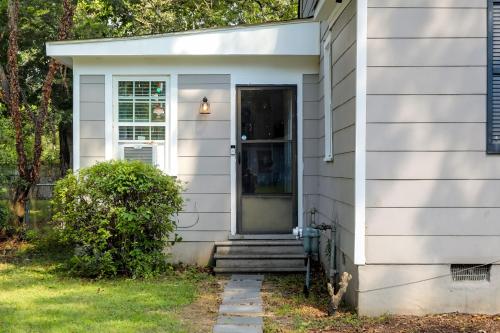 a white house with a front door and stairs at Less Than 1 Mi to Dtwn Updated Studio in North Greenwood! in Greenwood