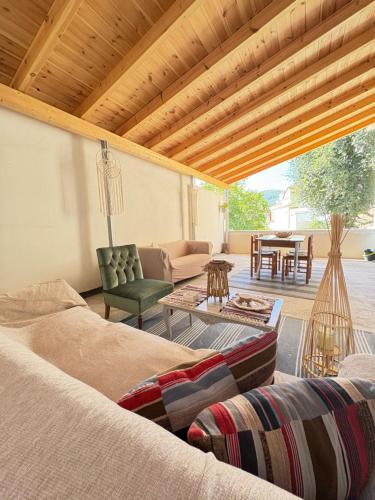 a living room with a couch and a table at MARY'S HOUSE - Urban Promenade Vibes in Tripolis