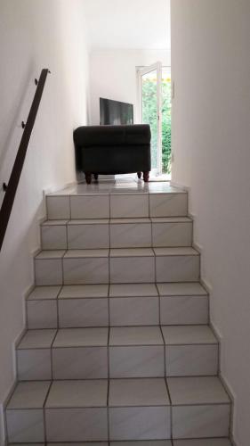 a stairway with a chair sitting on top of it at Apartment with Garden in Norderstedt county Hamburg, near Metro in Norderstedt