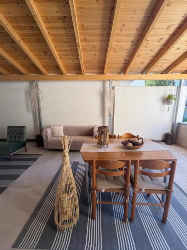 a living room with a table and a couch at MARY'S HOUSE - Urban Promenade Vibes in Tripolis
