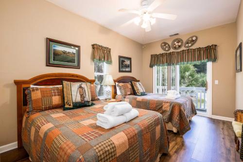 a bedroom with two beds and a window at 23 Davis Love in Fripp Island