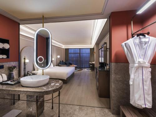 a hotel room with a bed and a bathroom at Mercure Beijing Zhongguancun in Beijing