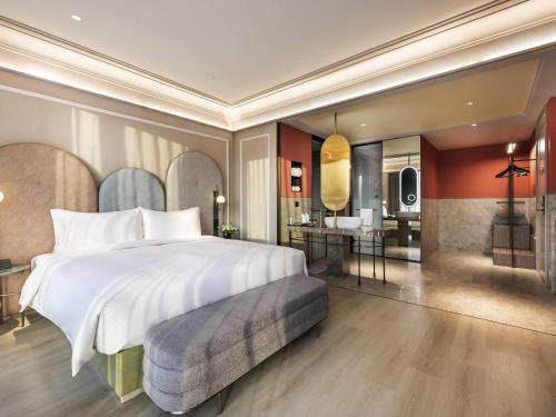 a bedroom with a large bed and a bathroom at Mercure Beijing Zhongguancun in Beijing
