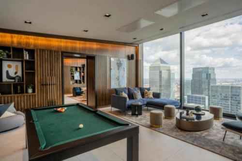 a living room with a pool table in a building at 3 Bedrm Luxury Serviced Apartment in Canary Wharf in London