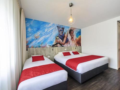 two beds in a room with a painting on the wall at ibis Styles Almere in Almere