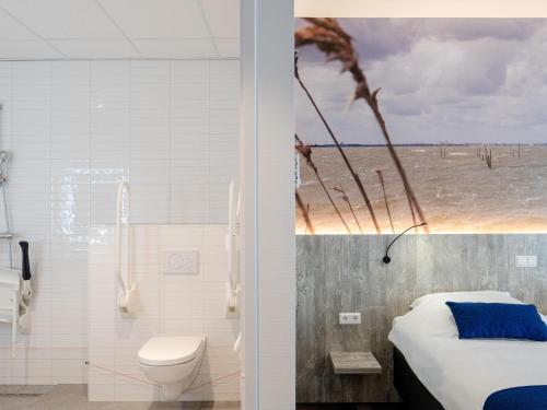 a bathroom with a bed a toilet and a shower at ibis Styles Almere in Almere