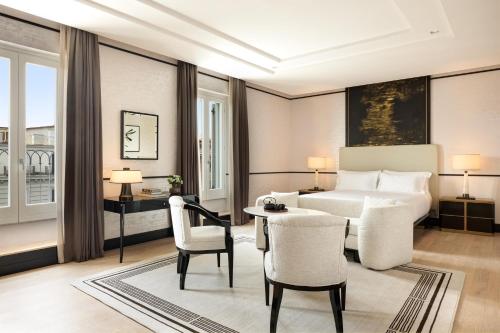 a hotel room with a bed and a table and chairs at Nobu Hotel Roma in Rome