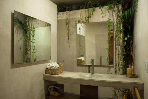 a bathroom with a sink and a mirror at Villa Noyollo - Alberca Privada - Punta Pérula in Pérula