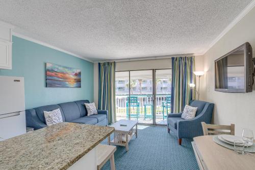 a living room with a couch and a table at Steps to Galveston Beach Corner-Unit Condo! in Galveston