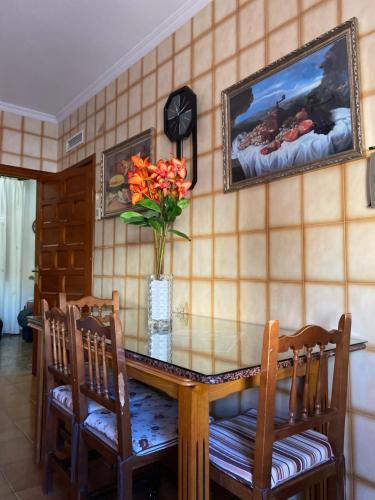 a dining room table with a vase of flowers on it at Casa-Villa en Lorca relax vistas y piscina privada in Lorca