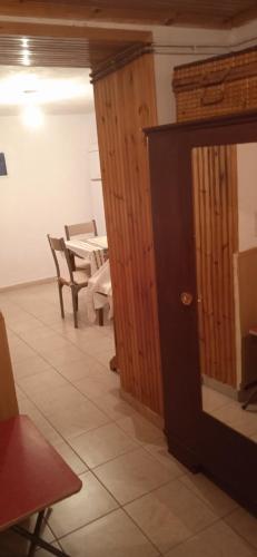 a room with a table and chairs and a door at Σπίτι στα Έλατα in Palaiochórion