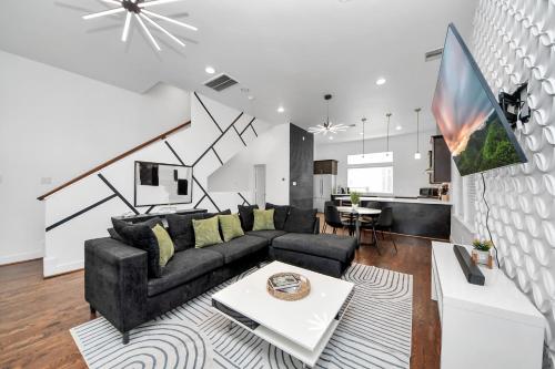 a living room with a couch and a table at AMAZING ROOFTOP! DOWNTOWN SKYLINE VIEWS!!! SLEEPS 15 in Houston