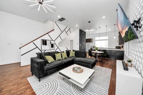 a living room with a couch and a table at AMAZING ROOFTOP! DOWNTOWN SKYLINE VIEWS!!! SLEEPS 15 in Houston