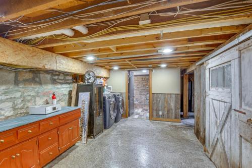 a kitchen with wooden ceilings and a room with a refrigerator at Stay and Sip Group Ranch at Shamrock Hills Vineyard in Excelsior Springs