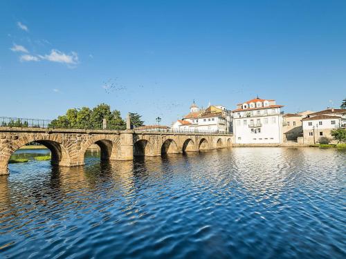 a bridge over a river in a city with buildings at ibis Styles Chaves in Chaves