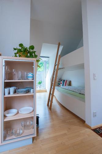 a room with a bunk bed with a ladder at Gästehaus Eisenerz in Eisenerz