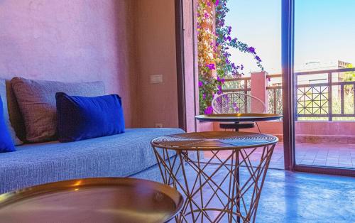 a living room with a couch and two tables at Waky Club - Fabulous Flat in Sraghna