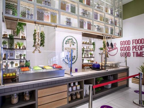 a fast food restaurant with a counter with food at Mercure Tangerang BSD City in Tangerang