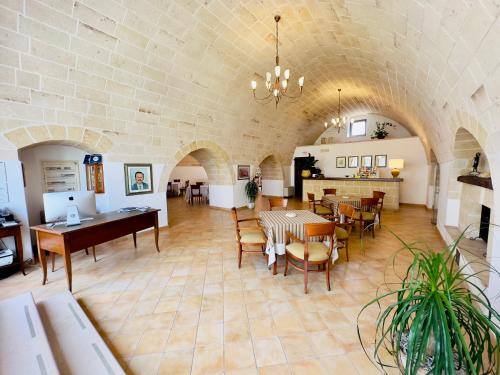 a dining room with tables and chairs in a building at Masseria Torre Spagnola in Matera