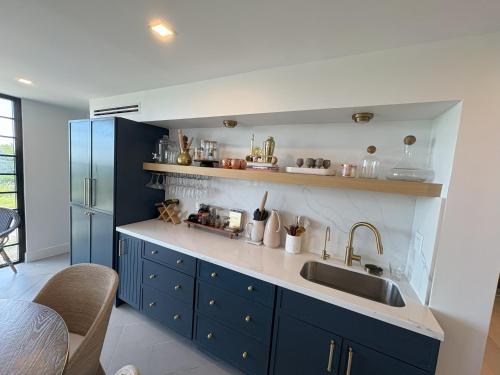 a kitchen with a sink and a blue refrigerator at Beach House in Placida