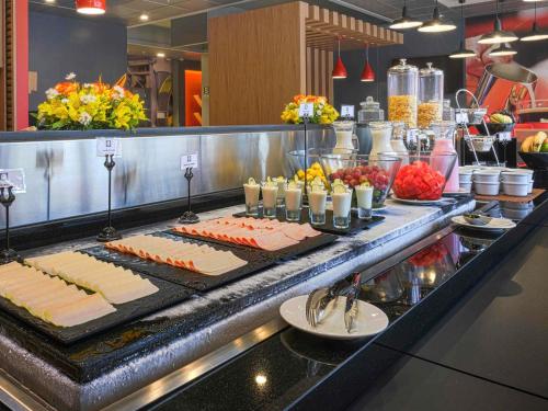 a buffet line with meats and cheese on a counter at ibis Trujillo in Trujillo