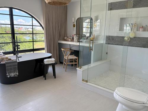 a bathroom with a shower and a toilet and a sink at Beach House in Placida