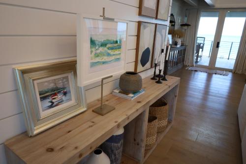 a room with a wooden table with paintings on the wall at Beach House in Placida