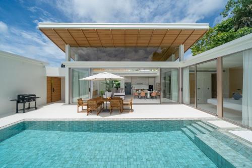 a house with a swimming pool and a villa at Luxury villa 3-4 bedroom near Bangtao beach in Phuket Town