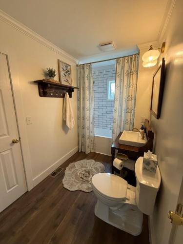 a bathroom with a toilet and a sink at Juanitas Garden Cottage in Jonesville
