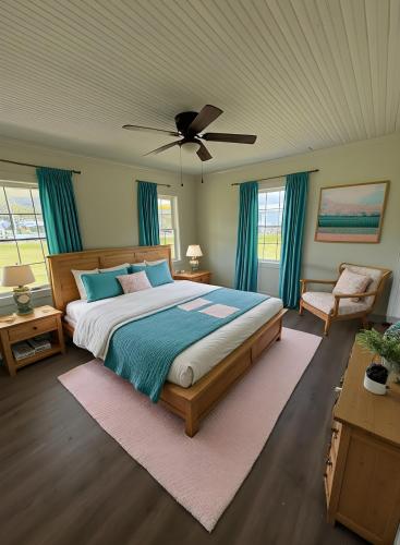a bedroom with a bed and a ceiling fan at Juanitas Garden Cottage in Jonesville