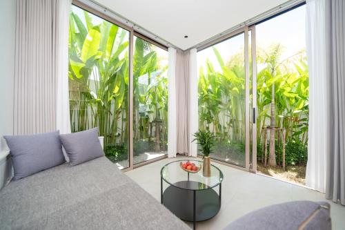 a living room with a couch and a glass table at Luxury villa 3-4 bedroom near Bangtao beach in Phuket Town