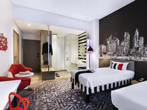 a hotel room with a bed and a desk at ibis Styles Dubai Airport Hotel in Dubai