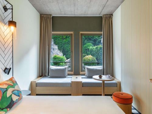 a hotel room with a bed and a window at Mercure Luxembourg Off Kirchberg in Luxembourg