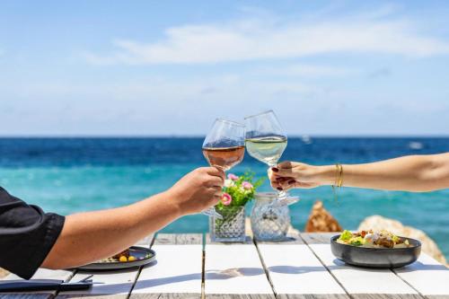 two people sitting at a table with glasses of wine at BijBlauw in Willemstad