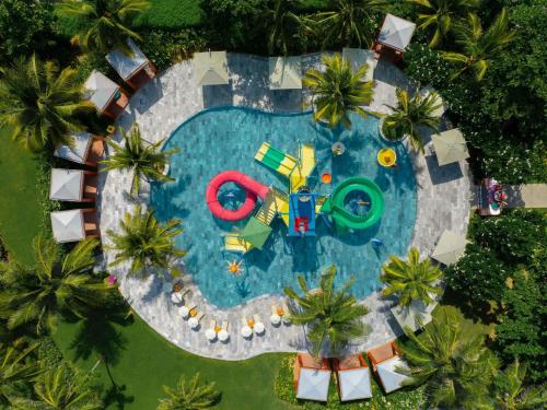 an overhead view of a swimming pool with a float at Mövenpick Resort Cam Ranh in Cam Ranh