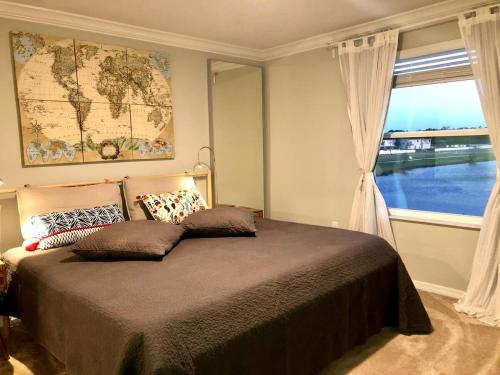 a bedroom with a large bed and a window at NEW Home 3 Bedrooms Water View Disney Universal in Kissimmee