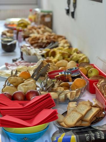 a table topped with lots of different types of food at POUSADA MIRAMAR in Arraial do Cabo