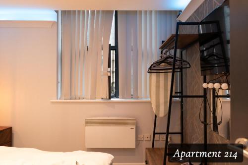 a room with a bed and a window at The Opulence Bradford in Bradford