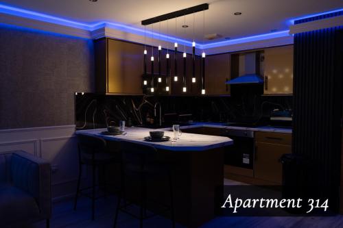 a kitchen with a island in the middle of a room at The Opulence Bradford in Bradford