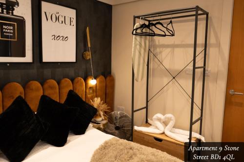 a bedroom with a bed and a glass shower at The Opulence Bradford in Bradford