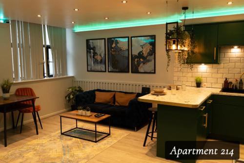 a kitchen and living room with a couch and a table at The Opulence Bradford in Bradford