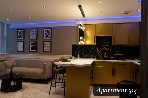 a kitchen with a table and a couch in a room at The Opulence Bradford in Bradford