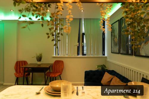 a living room with a table and a dining room at The Opulence Bradford in Bradford