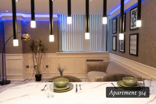 a dining room with a table and chairs at The Opulence Bradford in Bradford
