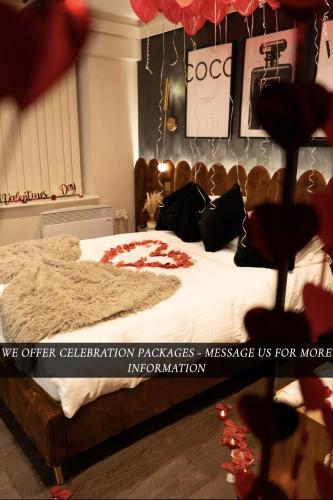a bedroom with a bed with a cat laying on it at The Opulence Bradford in Bradford